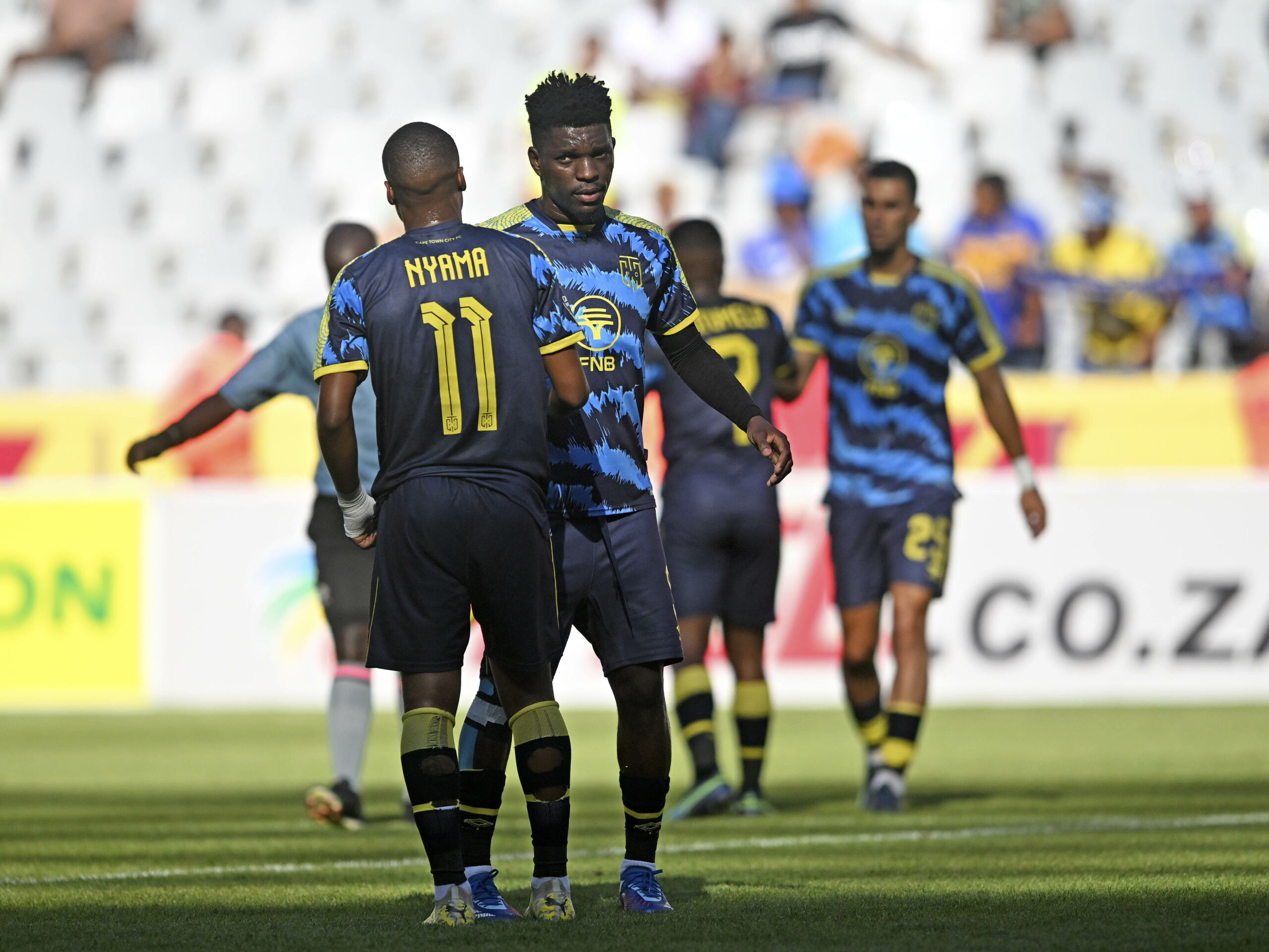Tshegofatso Nyama and Fidel Brice Ambina of Cape Town City celebrate victory at the final whistle after the DStv Premiership 2023/24 football match between Cape Town Spurs and Cape Town City at Cape Town Stadium