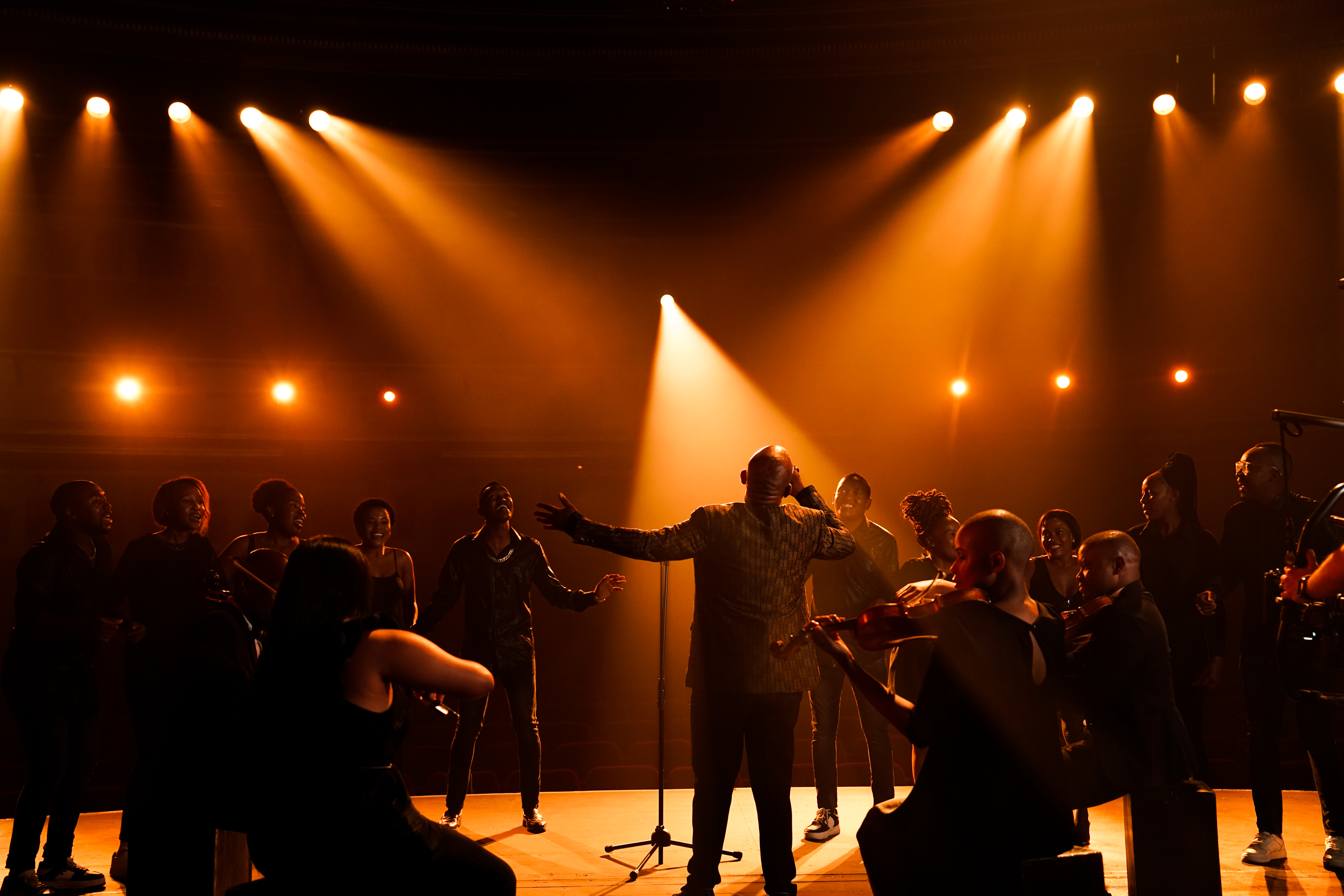 Lebo M with an Orchestra on stage at Artscape Theatre