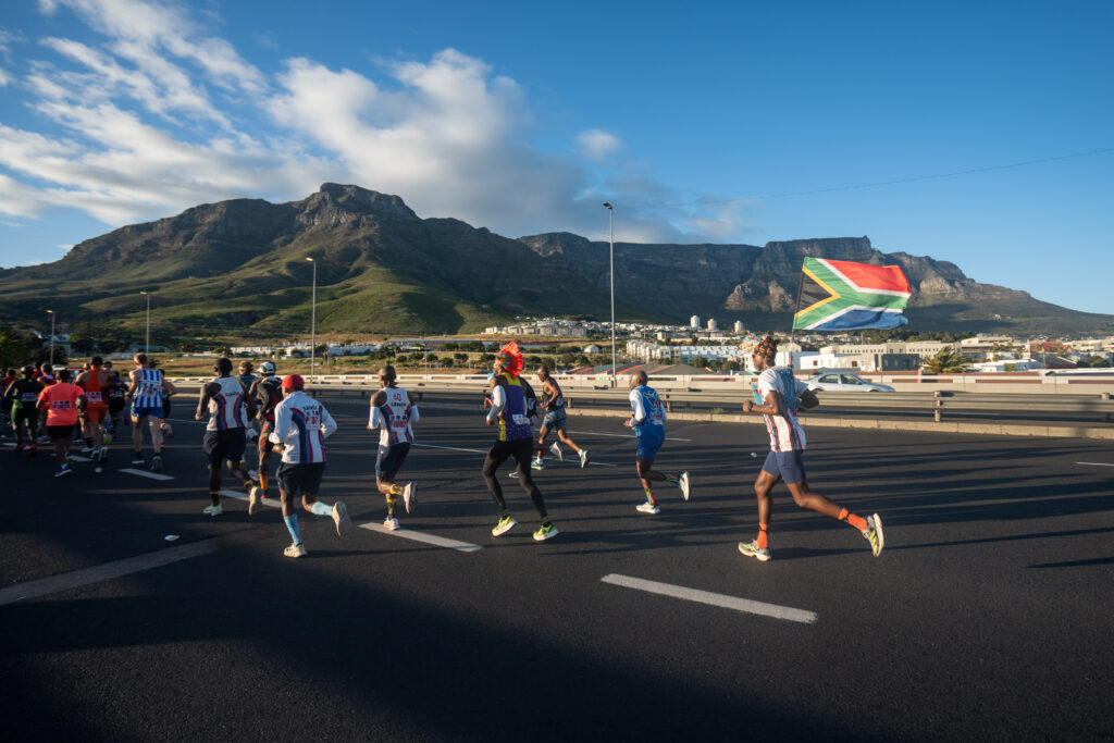 Cape Town Marathon runners on Nelson Mandela Boulevard, Foreshore, with Table Mountain as backdrop
