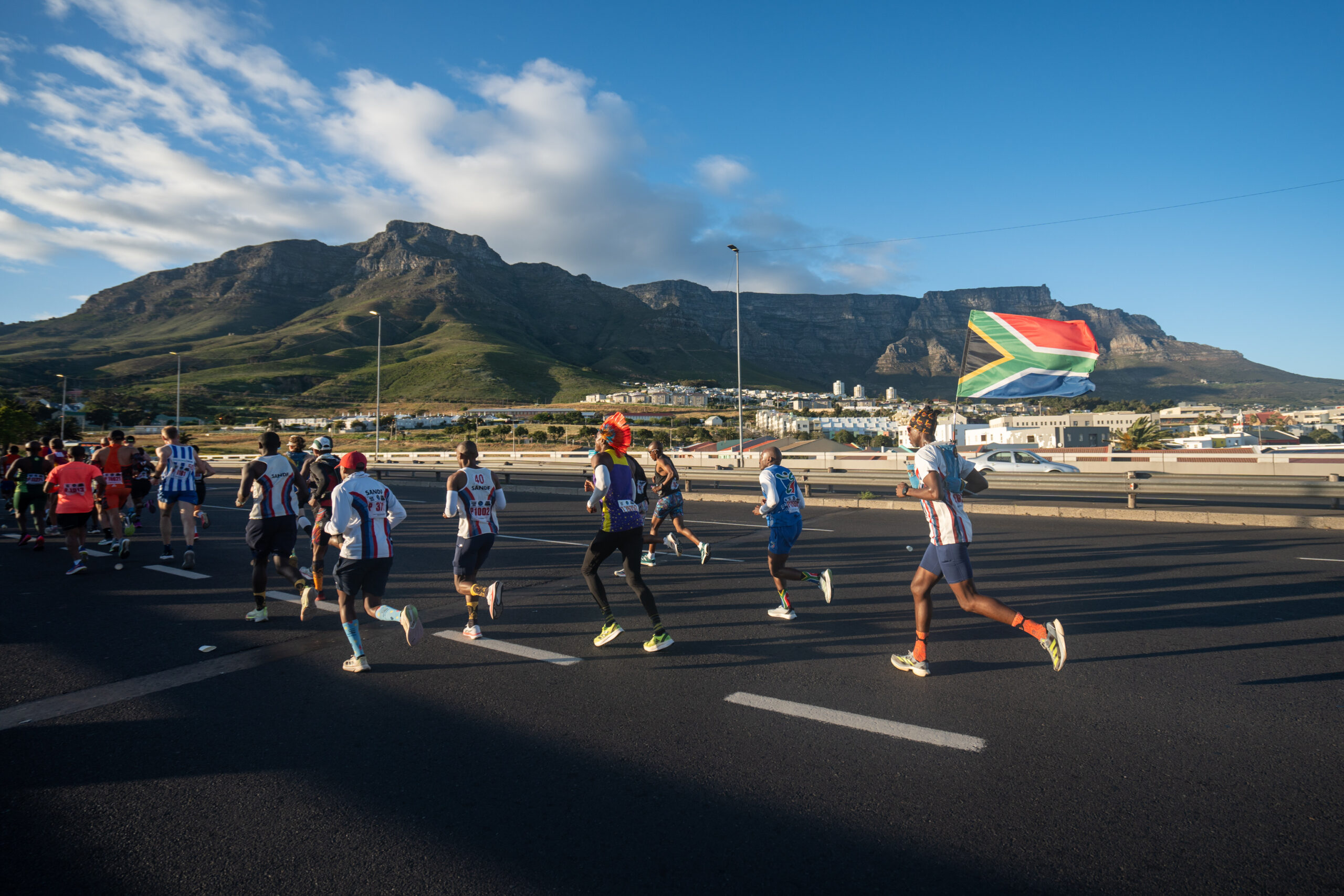 Cape Town Marathon runners on Nelson Mandela Boulevard, Foreshore, with Table Mountain as backdrop