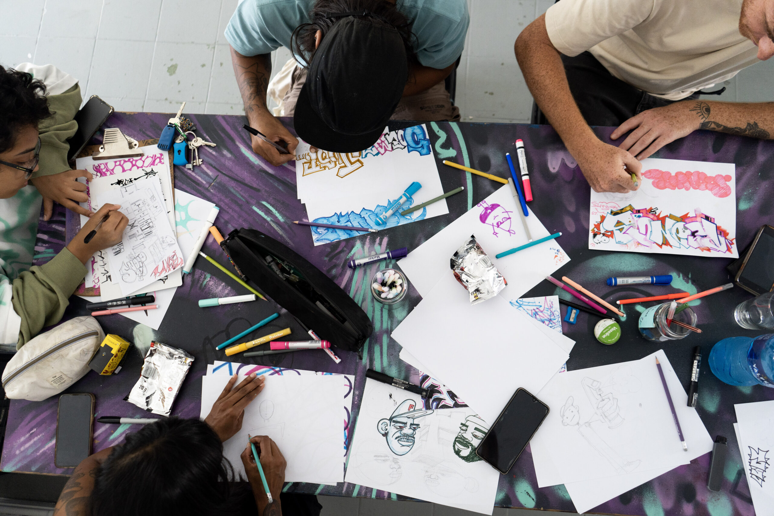 Khamissa Art Festival young people drawing and colouring on a table with pens and paper