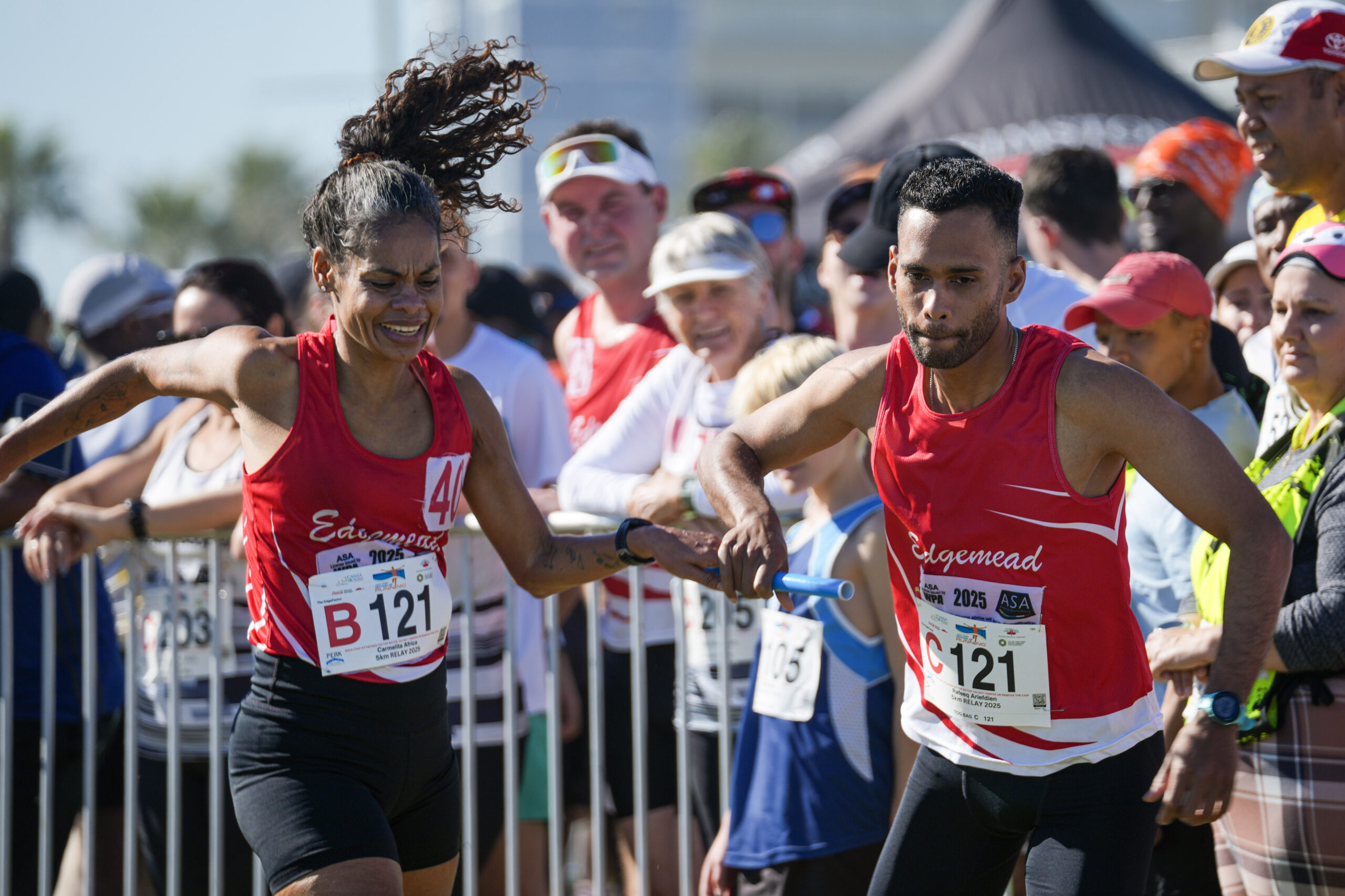 Edgemead Club runners exchange a baton during a 5x5km relay at Cape Town Festival of Running 2025