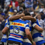 DHL Stormers players huddle after scoring a try