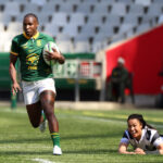 Springbok Women winger Ayanda Malinga with ball in hand runs past a fallen Barbarian player