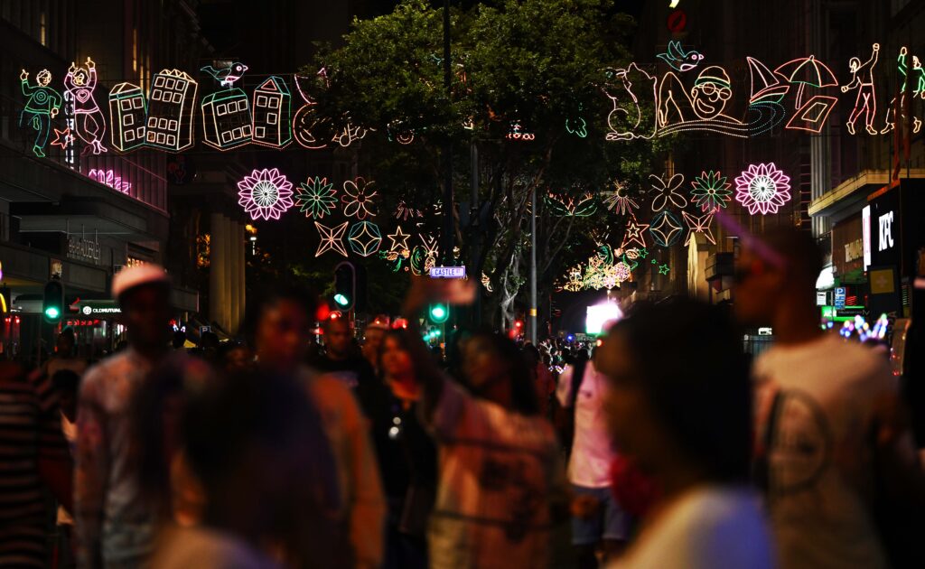 Residents and visitors on Adderley Street enjoying the assortment of festive lights on display